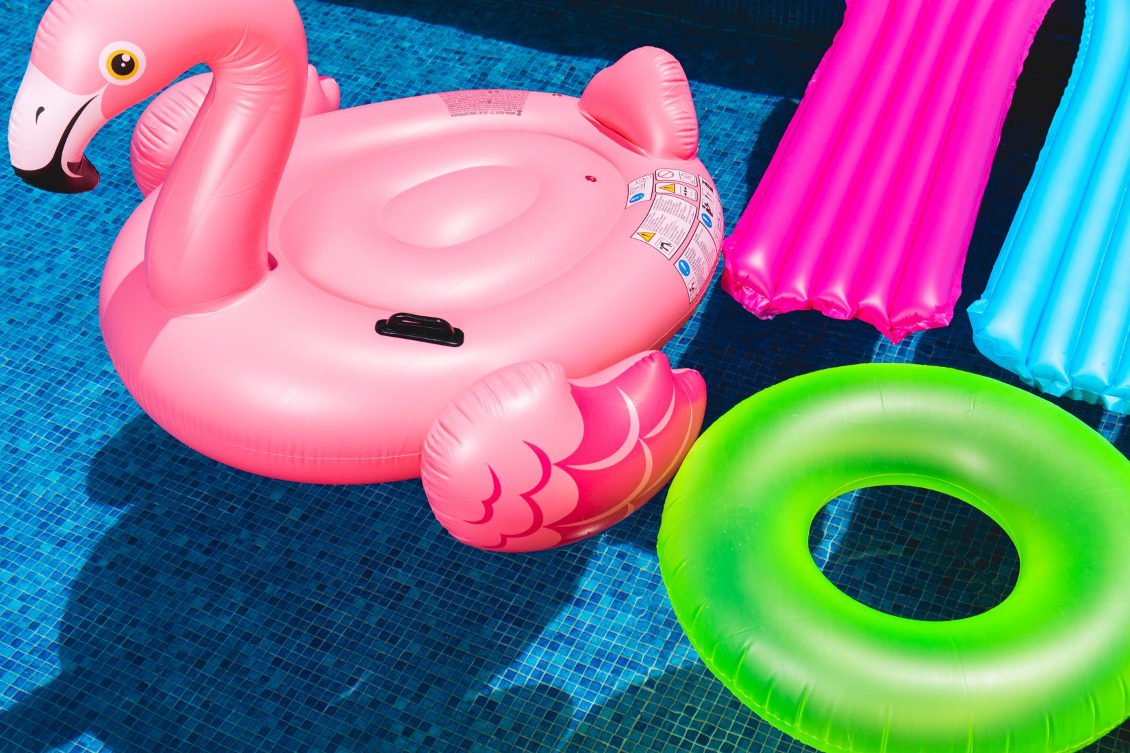 Colorful swim toys floating in a pool equipped with a pool heating system