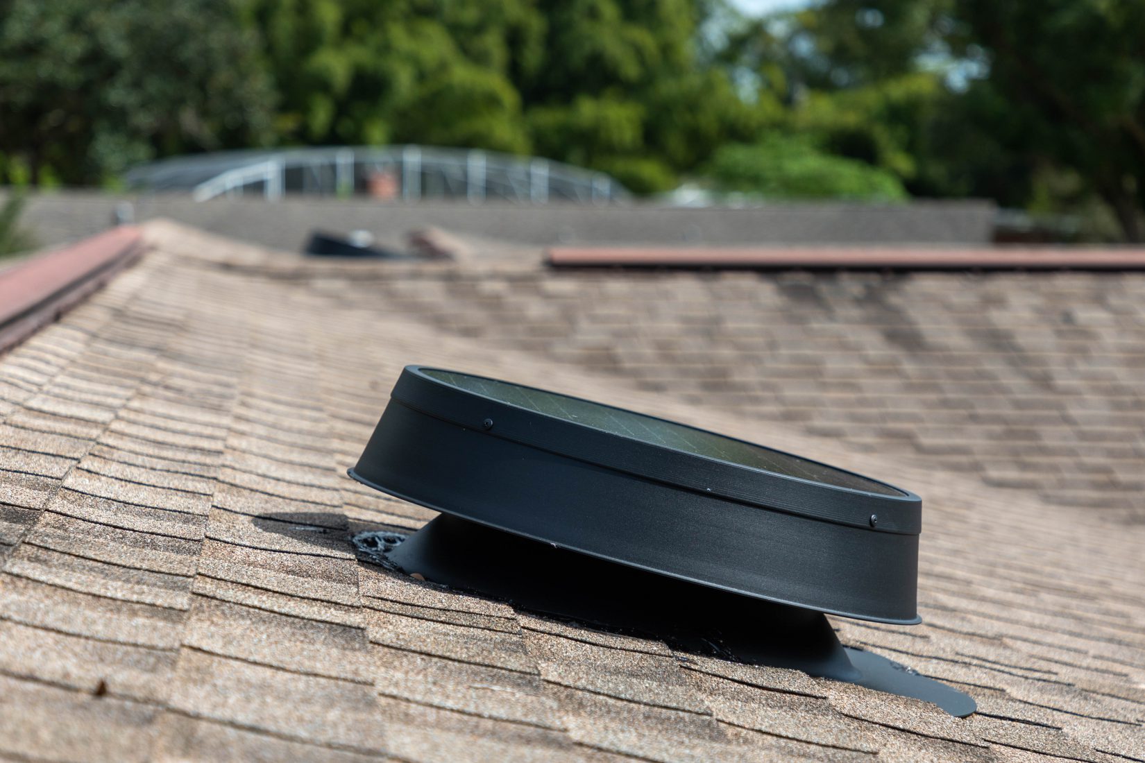 Solar attic fan affixed to roof